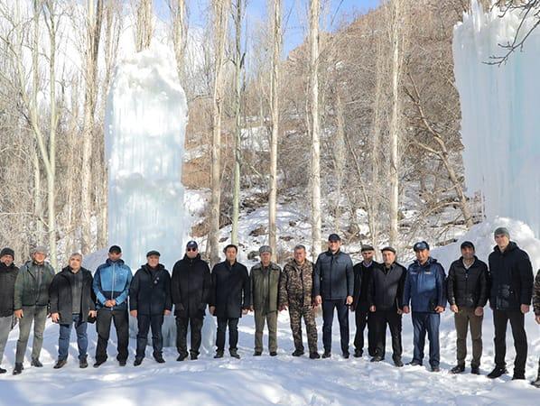 Men standing in front of ice stupas